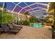 Relaxing poolside patio with lounge chairs at sunset at 17812 Doe Creek Ct, Parrish, FL 34219