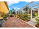 Brick paved patio area with lush landscaping and plants at 17812 Doe Creek Ct, Parrish, FL 34219