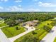 Aerial view of a luxurious home with a large yard and circular driveway at 17812 Doe Creek Ct, Parrish, FL 34219