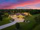 Luxury home with a large driveway and beautiful landscaping at sunset at 17812 Doe Creek Ct, Parrish, FL 34219