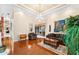 Spacious living room with hardwood floors, comfortable seating, and large artwork at 17812 Doe Creek Ct, Parrish, FL 34219