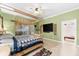 Main bedroom with large TV and en-suite bathroom access at 17812 Doe Creek Ct, Parrish, FL 34219