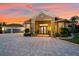 House exterior showcasing a beautiful entrance and landscaping at sunset at 17812 Doe Creek Ct, Parrish, FL 34219