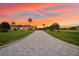 Long driveway leading to a luxurious home at sunset at 17812 Doe Creek Ct, Parrish, FL 34219