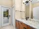 Bathroom with granite countertop and a door to the outside at 17812 Doe Creek Ct, Parrish, FL 34219