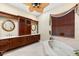 Spa-like bathroom with a soaking tub and walk-in shower at 17812 Doe Creek Ct, Parrish, FL 34219