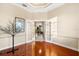 Home office with hardwood floors and French doors leading to hallway at 17812 Doe Creek Ct, Parrish, FL 34219