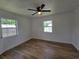 Bright bedroom with wood-look floors and ceiling fan at 100 N Duncan Ave, Clearwater, FL 33755