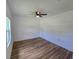 Bright bedroom with hardwood floors and ceiling fan at 100 N Duncan Ave, Clearwater, FL 33755