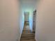Clean hallway with light walls and wood-look flooring at 100 N Duncan Ave, Clearwater, FL 33755