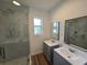 Elegant bathroom with dual vanities and a glass shower at 100 N Duncan Ave, Clearwater, FL 33755