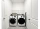 Bright laundry room with washer, dryer, and shelving at 10827 Charlotte Dr, Parrish, FL 34219