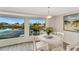 Dining area with water views and whitewashed table and chairs at 846 Jolanda Cir, Venice, FL 34285