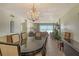Bright dining room with chandelier and ocean view at 19 Whispering Sands Dr # 204, Sarasota, FL 34242