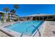 Sparkling community pool surrounded by lush landscaping at 19 Whispering Sands Dr # 204, Sarasota, FL 34242