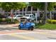 A three-wheeled vehicle driving through Siesta Key at 19 Whispering Sands Dr # 204, Sarasota, FL 34242