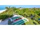 Aerial view of shuffleboard courts near beach and canal at 19 Whispering Sands Dr # 204, Sarasota, FL 34242