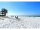 White sand beach with lounge chairs and ocean view at 19 Whispering Sands Dr # 204, Sarasota, FL 34242