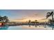 Relaxing pool area with sunset views and lounge chairs at 19 Whispering Sands Dr # 204, Sarasota, FL 34242
