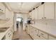 Bright kitchen features ample counter space and white cabinetry at 19 Whispering Sands Dr # 204, Sarasota, FL 34242
