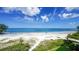 Oceanfront view of beach with white sand and people enjoying the sun at 19 Whispering Sands Dr # 204, Sarasota, FL 34242