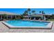 Relaxing community pool area with plenty of lounge chairs at 19 Whispering Sands Dr # 204, Sarasota, FL 34242