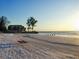 Peaceful beach with white sand and a relaxing beach chair at 19 Whispering Sands Dr # 204, Sarasota, FL 34242