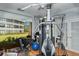 Well-equipped home gym featuring various exercise machines and free weights at 19 Whispering Sands Dr # 204, Sarasota, FL 34242