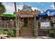 Entrance to The Cottage on the Key restaurant with stairs and outdoor seating at 19 Whispering Sands Dr # 204, Sarasota, FL 34242