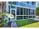 Bright, sunlit condo exterior with glass walls at 2100 Benjamin Franklin Dr # 105, Sarasota, FL 34236
