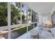 Enclosed patio with seating area and view of garden at 2100 Benjamin Franklin Dr # 105, Sarasota, FL 34236