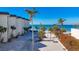 Beachfront view of Lido Harbour South, showing the building and sandy beach at 2100 Benjamin Franklin Dr # 105, Sarasota, FL 34236