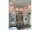 Spa-like shower with multiple shower heads and a built-in seat at 4819 Higel Rd, Sarasota, FL 34242