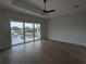 Main bedroom with hardwood floors and private balcony at 4819 Higel Rd, Sarasota, FL 34242