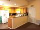Galley kitchen with wood cabinets and granite counters at 2607 River Preserve Ct # 2607, Bradenton, FL 34208