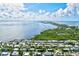 Wide aerial showcasing waterfront homes and the Gulf of Mexico at 780 Tarawitt Dr, Longboat Key, FL 34228