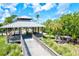 Quaint gazebo with wooden bridge and surrounding lush tropical landscape at 780 Tarawitt Dr, Longboat Key, FL 34228