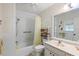 Clean bathroom with shower/tub combo, vanity, and linen storage at 780 Tarawitt Dr, Longboat Key, FL 34228