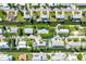 Bird's eye view of canal front properties with swimming pools at 780 Tarawitt Dr, Longboat Key, FL 34228