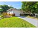 Single story home with attached garage and manicured lawn at 780 Tarawitt Dr, Longboat Key, FL 34228