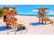 Two lifeguard stands on the beach with rescue vehicle at 780 Tarawitt Dr, Longboat Key, FL 34228