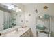 Bright bathroom with vanity, mirror, and seashell themed decor at 780 Tarawitt Dr, Longboat Key, FL 34228