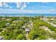 Aerial view of community with ocean, pond, and lush vegetation at 780 Tarawitt Dr, Longboat Key, FL 34228