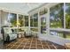 Relaxing sunroom overlooking a canal, furnished with two armchairs at 780 Tarawitt Dr, Longboat Key, FL 34228
