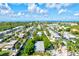 Aerial view showcasing waterfront homes and lush landscaping at 780 Tarawitt Dr, Longboat Key, FL 34228