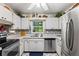 Efficient kitchen with stainless steel appliances and tile backsplash at 780 Tarawitt Dr, Longboat Key, FL 34228