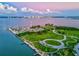 Aerial view of a waterfront park with marina and city skyline at 780 Tarawitt Dr, Longboat Key, FL 34228