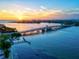 Stunning sunset aerial view of a coastal town with bridge and boats at 780 Tarawitt Dr, Longboat Key, FL 34228