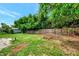 Large backyard with a wooden fence and lots of green space at 2900 Siesta Dr, Venice, FL 34293