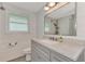 Updated bathroom with gray vanity, new flooring and fixtures at 2900 Siesta Dr, Venice, FL 34293